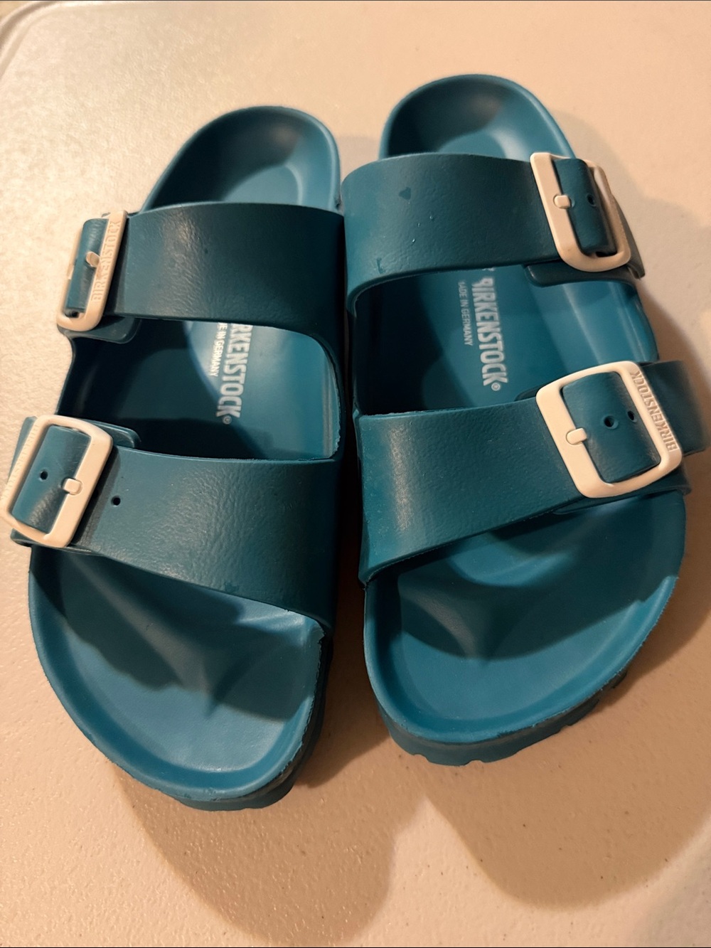 Birkenstock women’s Arizona EVA Sandals in Teal Blue